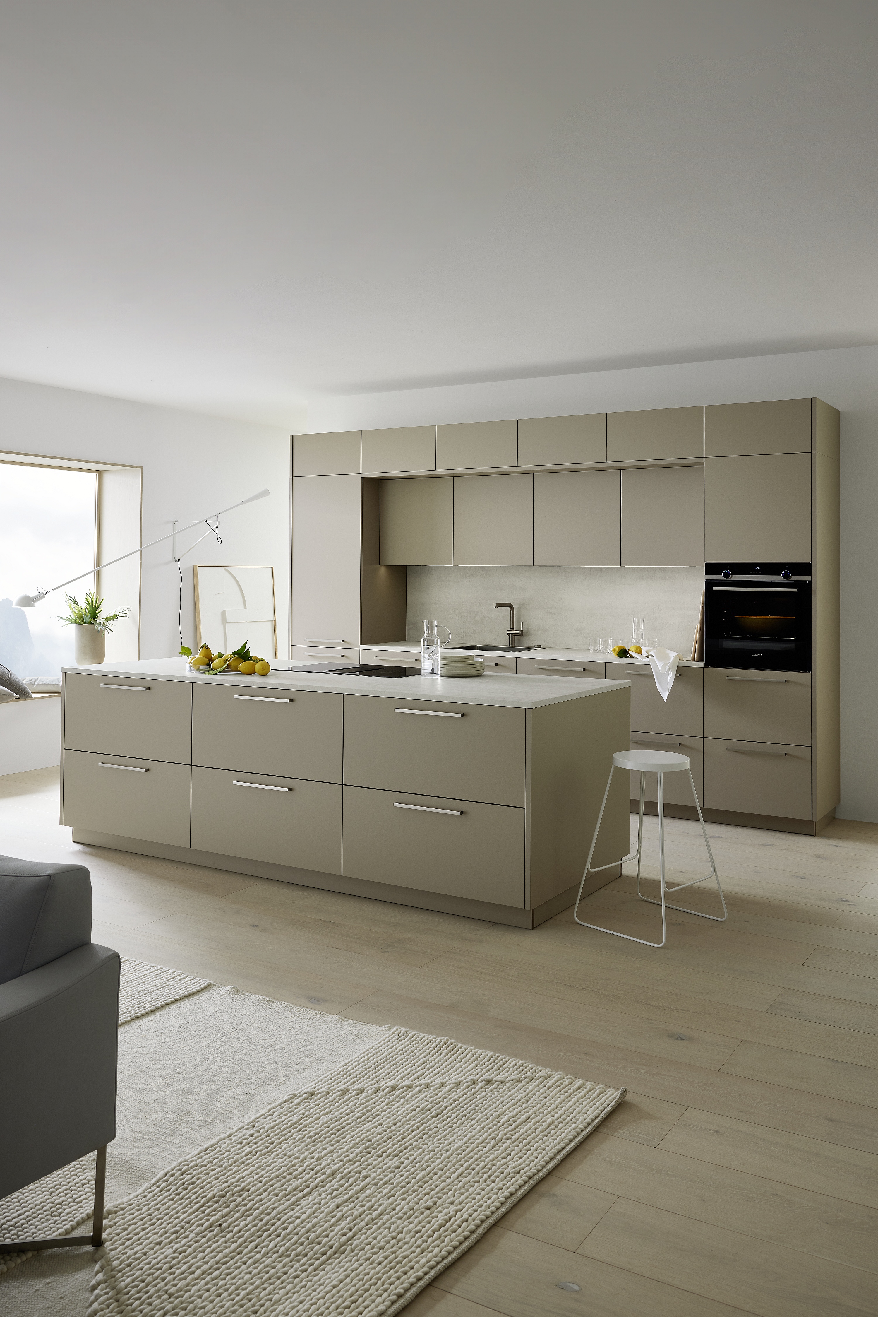 Nolte wandbündig eingebaute Küchenzeile in Greige davor freistehende Küchentheke